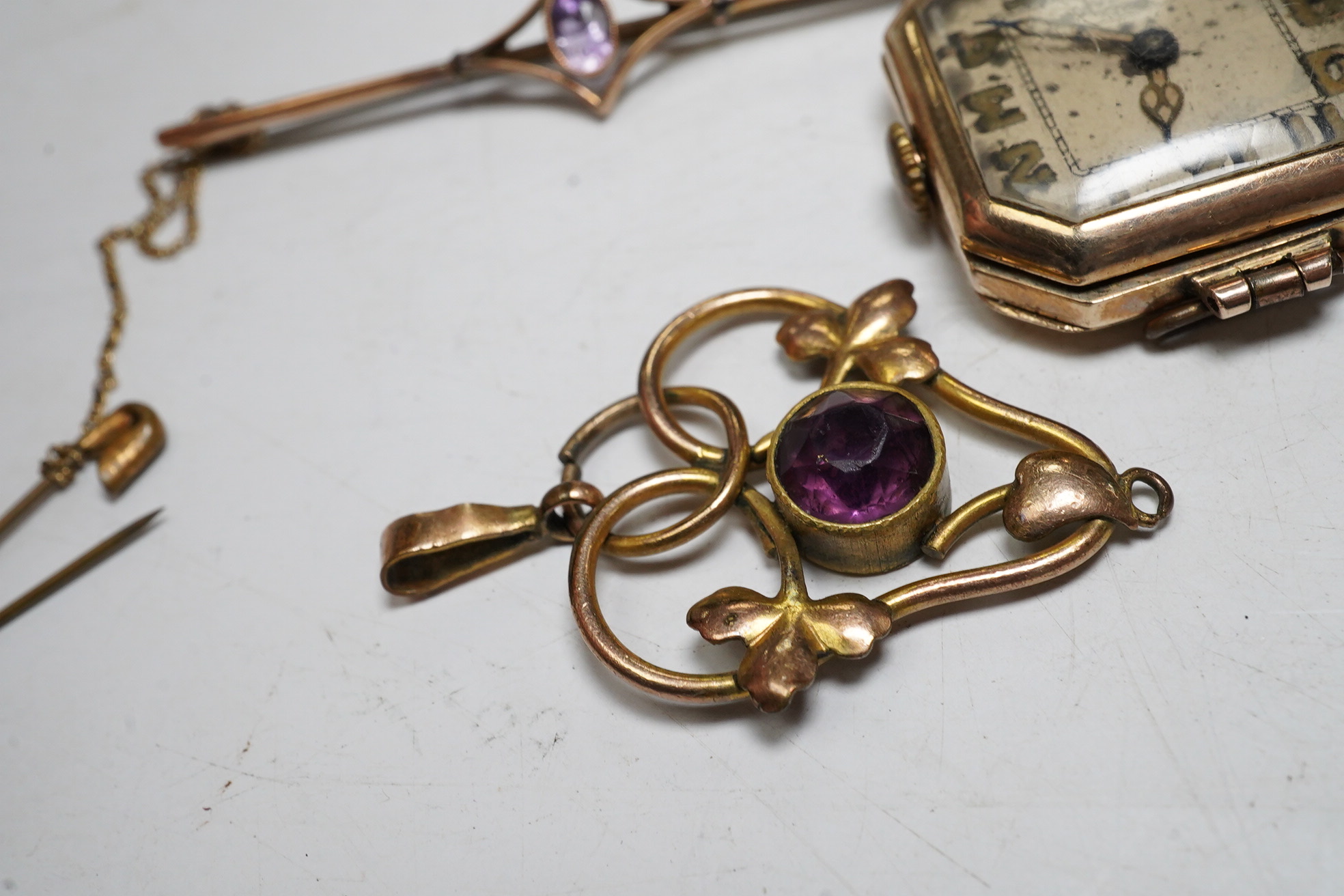 An enamelled 15ct gold Royal Engineer's sweethearts brooch with diamond chips, 5cm, gross 5.8 grams, a gold wrist watch, a 9ct gold and amethyst bar brooch, 2.1 grams, a ruby and diamond chip set 9ct gold dress ring, gro